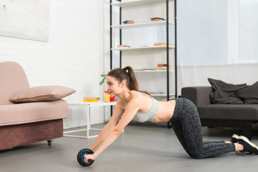 fit young woman performing an abdominal workout using an Ab Wheel, engaging her core and arms.