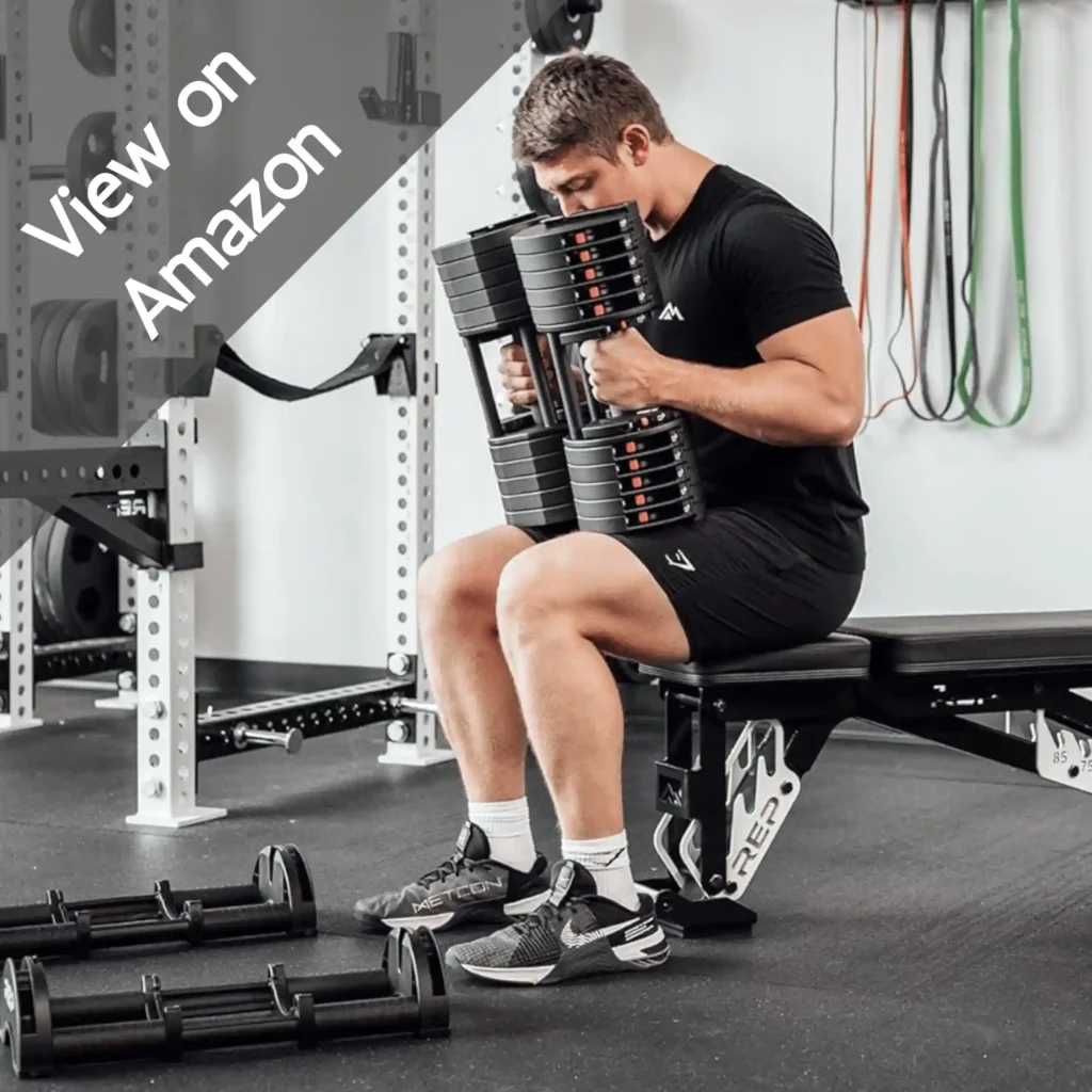 Boy sited on a chare with Rep QuickDraw Adjustable Dumbbells 